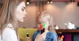 Happy mom and daughter hugging in a cafe. High Bitrate, prores.