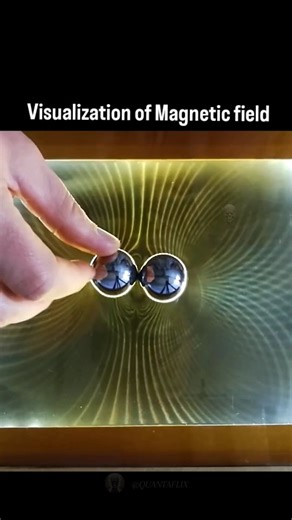 Quantaflix 🚀 on Instagram: "This magnetic field visualization is created using ferrocell. A ferrocell uses a thin layer of ferrofluid between glass and LED light to reveal magnetic field patterns. The light bends along the magnetic field lines, creating colorful visualizations of magnetic flux."