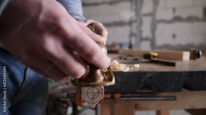 joiner planes a wooden plank with a hand planer. slow motion 180 fps. Design, carpentry, craftsmanship and handwork concept