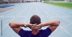 Rear view, man or athlete on racing track for runner, fitness and training on stadium with workout. Person, back or running field for thinking, competition or athletics outdoor for wellness and sport