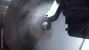 Precision machining and turning of a steel rod on a CNC lathe, a modern lathe for metal processing.
