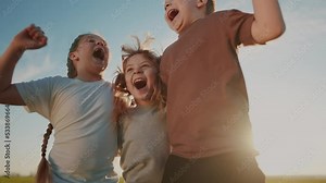 group of kids team hugging a jumping and rejoicing outdoors. happy family teamwork kid dream concept. family children lifestyle sisters brothers have fun hugging in the park in nature