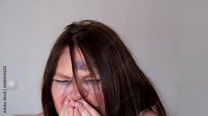 close-up of female tear-stained face, beaten woman with bruises and abrasions, quiet cry for help, concept of domestic violence, emotion of suffering from pain, kidnapping, being in danger