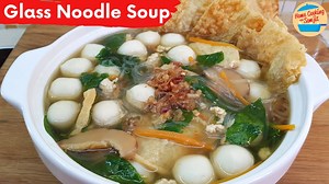 Glass Noodles Soup is sweet, tender and very healthy. It is perfect for a quick meal on its own, or even with rice. Enjoy! Ingredients ↓ Glass Noodle Soup Recipe with Fish Balls Ingredients: 220g of fish balls 100g of minced chicken 60g of dried glass noodles, soaked in the water for 20 minutes 1 liter of water 30g of sayur manis, or any leafy greens 80g of fish fuchok, or bean curd sheet with fish paste 65g of tofu puff 70g of shiitake mushroom 30g of carrot striped 1 tbsp of crispy fried shall
