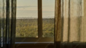 Window with curtains, window sill and clouds floating behind the glass, timelapse