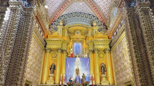 Ornate baroque altar inside Sanctuary of Guadalupe with gold details and sacred art