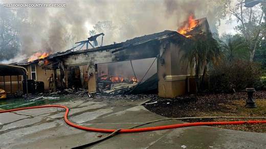 Firefighter hospitalized while battling large house fire in Lutz