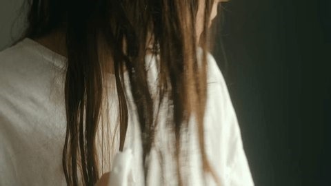 clip-4034424919-anonymous-young-woman-long-brunette-hair-applying