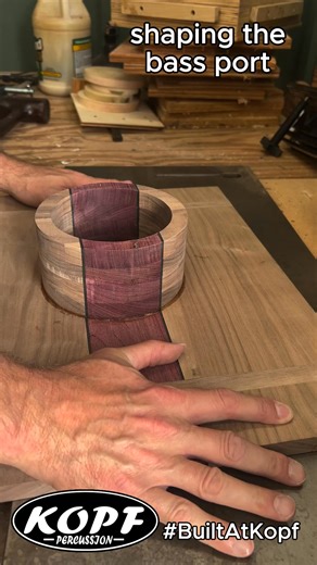 Shaping a Walnut and Purpleheart bass port. This is where the cajon starts to take it's shape. Slow passes on the router table and some cleanup at the sanding station. Up next is adding some splines. #BuiltAtKopf #KopfPercussion #walnut #purpleheart #cajon #handcraftedpercussion #instrumentbuilder #woodworking | Kopf Percussion