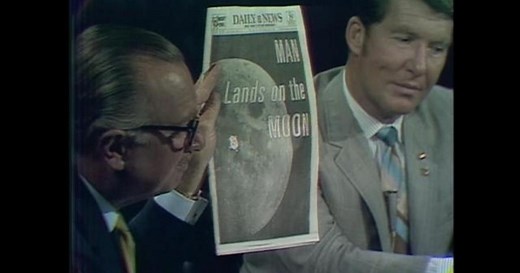 Walter Cronkite shows front-page headlines about moon landing