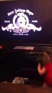 Baby afraid of the lion in the tv