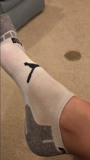 Taking off lose Nike Tanjun showing No Show Puma Socks.