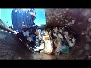 Waste Management garbage truck inside hopper view.