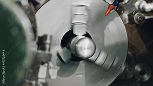 Witness a metal lathe in action, showcasing high-speed precision machining in an industrial setting. Experience the cutting tool and rotating workpiece in this dynamic process