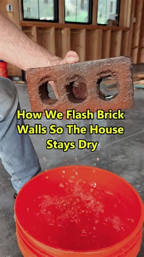 Brick soaks up water like a sponge. I put this brick wall in front of The New Guy’s house to show you what can happen over time with a driving rain -eventually the water goes through the brick and runs down the wall. So how do we stop this? We flash the brick above all the windows and doors and at each story. Here I’m using vinyl flashing. I tuck this up behind the cut in the house wrap, and bend it out ninety-degrees on top of the brick. The flashing can be held into position with cap nails, I’