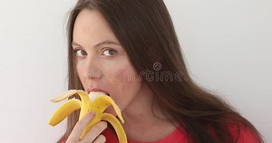 Attractive Woman Peeling and Eating a Big Banana Stock Video - Video of hold, hair: 116710481