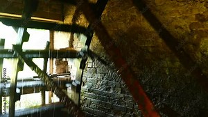 water mill showing gears run by water wheel - heritage flour mill shot in 4K