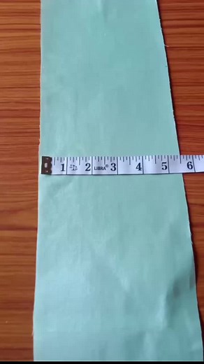 Sewing Decorative Designs on Light Blue Fabric