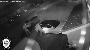 Two men use relay boxes to steal a Mercedes parked on a driveway