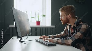 freelancer game designer creating new interface for video game, man working in home office