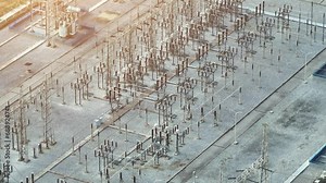 High voltage substations are secured areas equipped with advanced safety measures to protect workers and the public from potential electrical hazards. Aerial view drone.