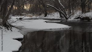 calm winter river scenery at dusk - Cache la Poudre River in Fort Collins, Colorado