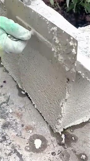 Plastering a concrete wall with professional masonry hand tools