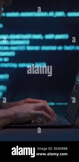 Coder or data scientist working on laptop in dark office at night with blue programming script lines on background. Coding, data analytics, machine learning work process. Vertical video Stock Video Footage - Alamy