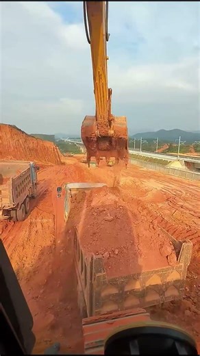Excavators Load Soil Onto Trucks