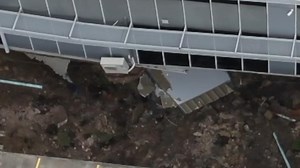 Wild moment building collapses in sinkhole