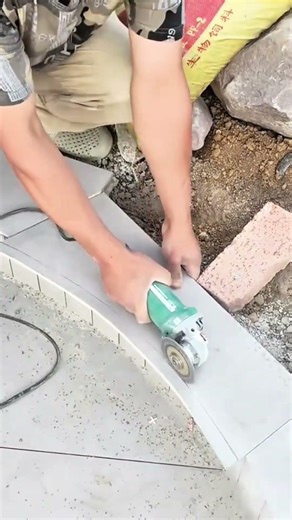 marking the gray tile with a pencil and cutting it using a power grinder to fit the curved edge well