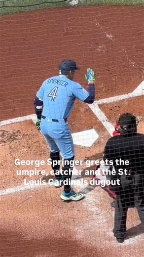 George Springer greets the umpire, catcher and the St Louis Cardinals dugout at his first at bat