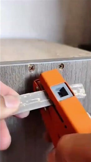 Drilling a screw into wooden board using electric power drill