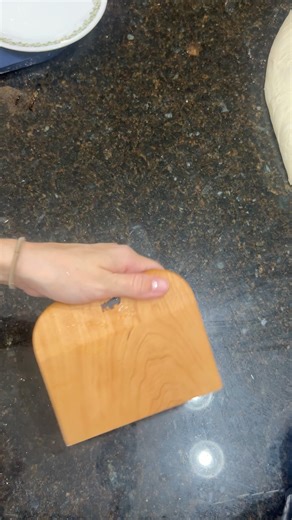 Dividing dough with a wooden bench scraper