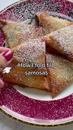 How I fold samosas using filo pastry. For this recipe you will need: Filo pastry, cut into long strips Banana slices Chocolate buttons Icing sugar for dusting (optional) 1. Place a banana slice and a giant chocolate button at the bottom right of the filo pastry. Using your fingers to hold the filling, fold the pastry, lining the bottom edge with the left edge. Now fold again as shown in the video, with each fold being lined against the edges of the pastry. Brush the end of the pastry with melted