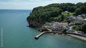 Babbacombe, South Devon, England: DRONE VIEWS: The drone circles Babbacombe beach and harbour wall as a tourist boat sails the coastline. Babbacombe is a popular UK holiday destination (Clip 14).