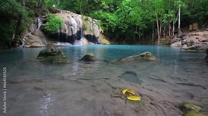 Erawan waterfall beautiful emerald lake and rocks in wild jungle forest in Erawan National park, Kanchanaburi, Thailand