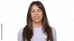 Angry Caucasian yong female screaming in anger and holding her head. Footage over white background in slowmotion