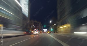 Driving after dark through the streets of Barcelona with Christmas lights. Time Lapse - Trail effect - vehicle shot - subjective view - 4K.(01)