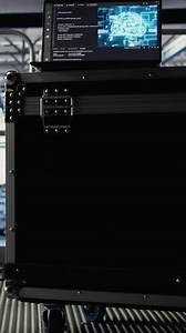 Vertical AI coding script running on laptop managing server farm mainframes powering networks. Artificial intelligence programming language on notebook in data center helping process datasets, jib up