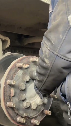 the process of removing a bolt on a truck rim using an impact tool#automobile