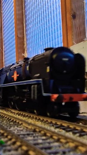 BR blue Rebuilt Merchant Navy Class steam loco running the fast train.