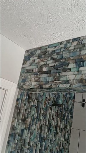 Glass tile mosaic install on ceiling, header, and accent wall of #tileshower