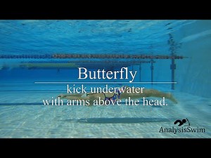 Butterfly kick underwater with arms above the head