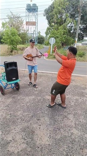 A team carrying traditional Thai drums in a parade during the era of high oil prices.