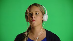 Download Blonde Woman Listens To Music While Chewing Bubble Gum  for free