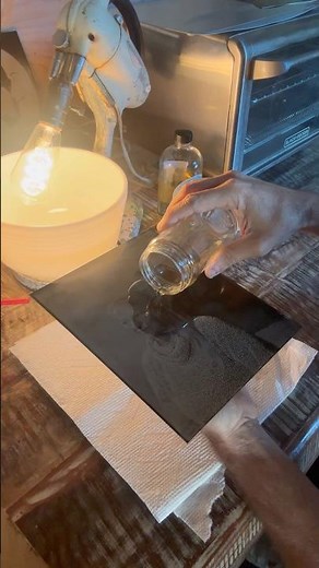 Pouring shellac on a tintype made using the historic wetplate process.