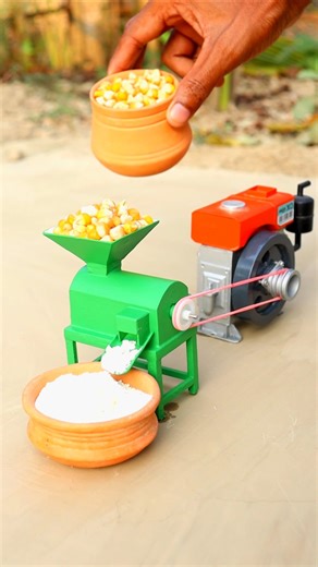 Corn is being ground into powder using a mini-machine.#tractor