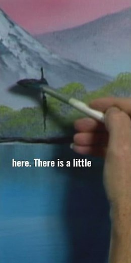 Bob Ross uses a fan brush to add some happy little trees into his painting