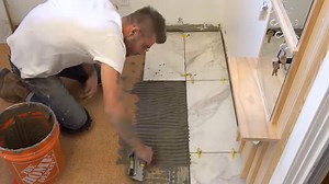 I tried installing large tiles… my neighbor just watched